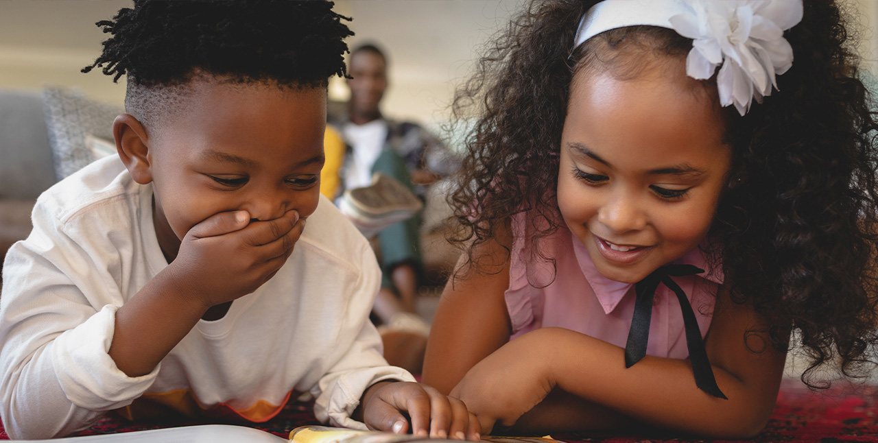 young boy and girl reading on the floor